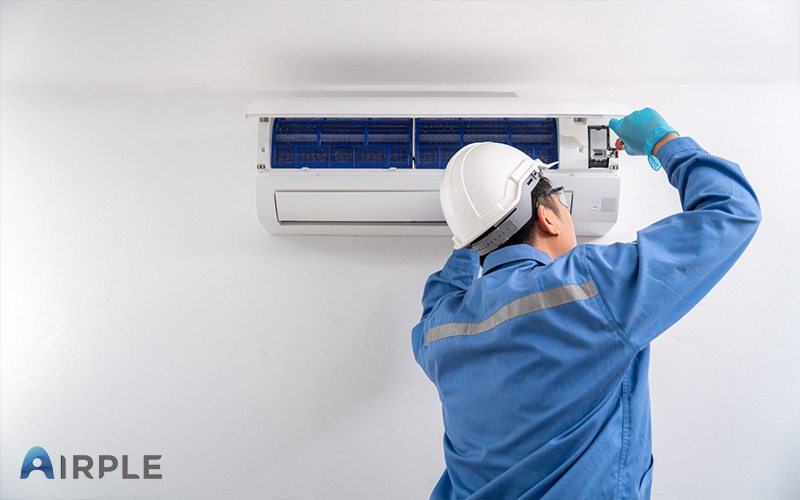 Technician working on aircon repair