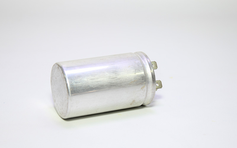 Close-up of an air conditioner capacitor component part.