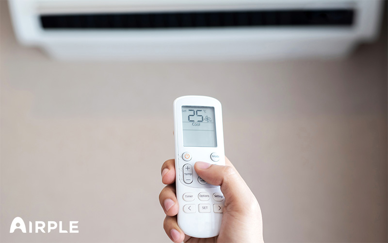 Person controlling aircon using remote