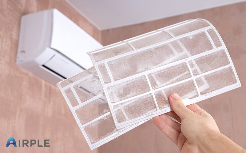 Aircon filter being cleaned