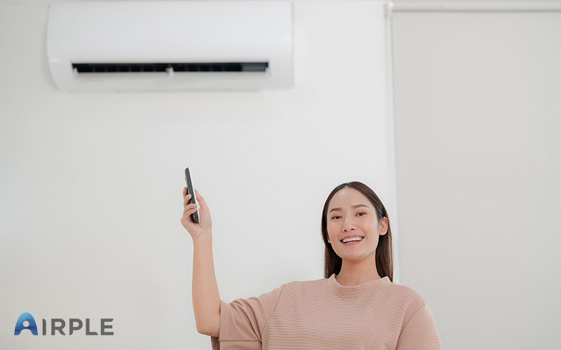 A woman showcasing her air conditioner
