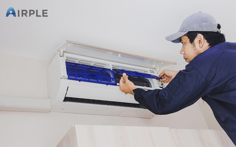 Maintenance worker checking on aircon