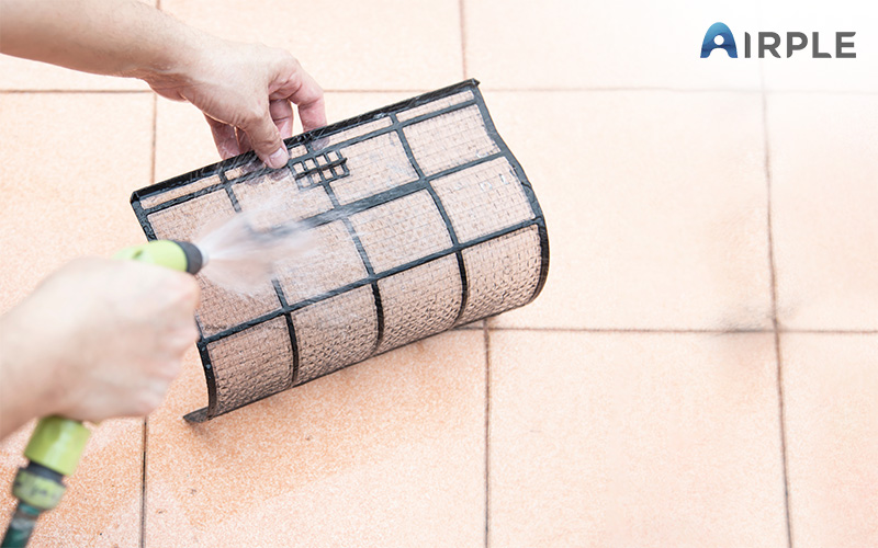 Washing off clogged aircon filters