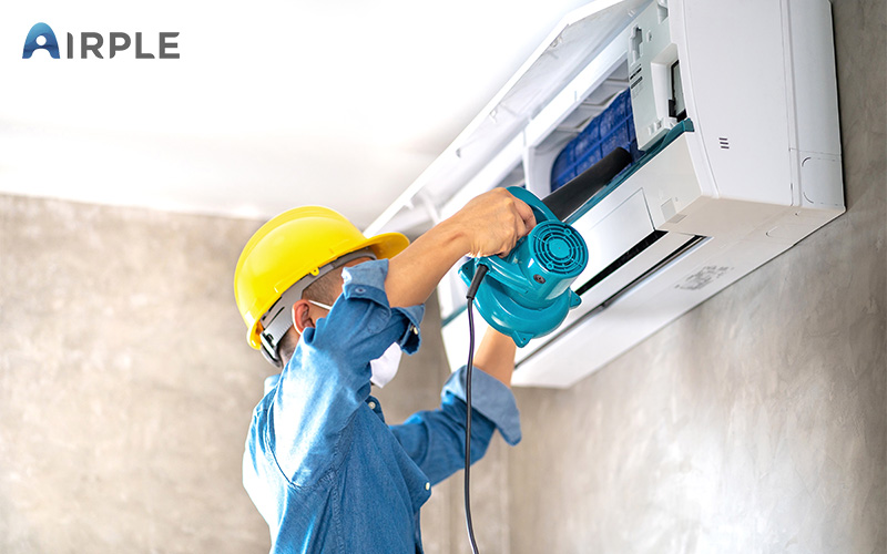 Technician performing maintenance on aircon